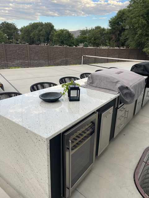 Outdoor kitchen with wine fridge and beverage center